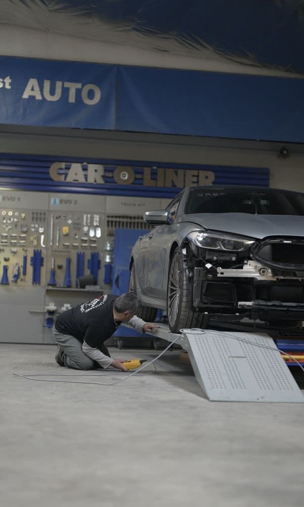 Mechanic working on repairing BMW at Century 1st Collision Center